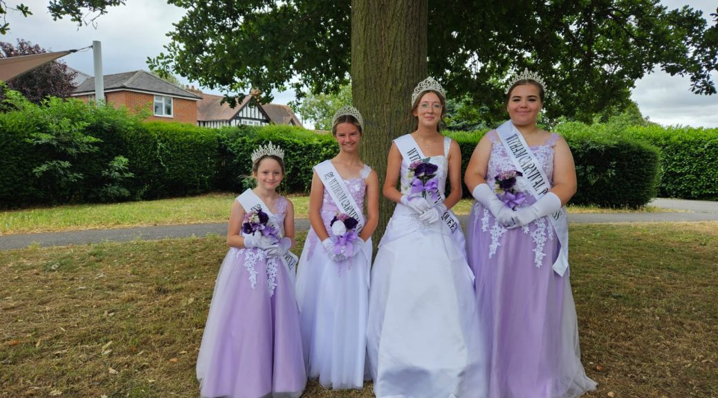 Four girls in front of tree wearing formal dresses